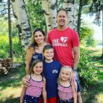 family posing in front of birch trees