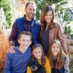 family posing with dog outdoors