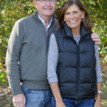 man and woman posing outdoors