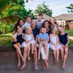 family posing seated outdoors