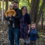 family posing in forest