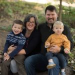 family posing in forest