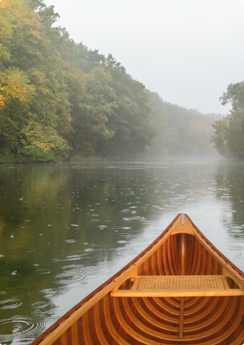 canoe on river with trees